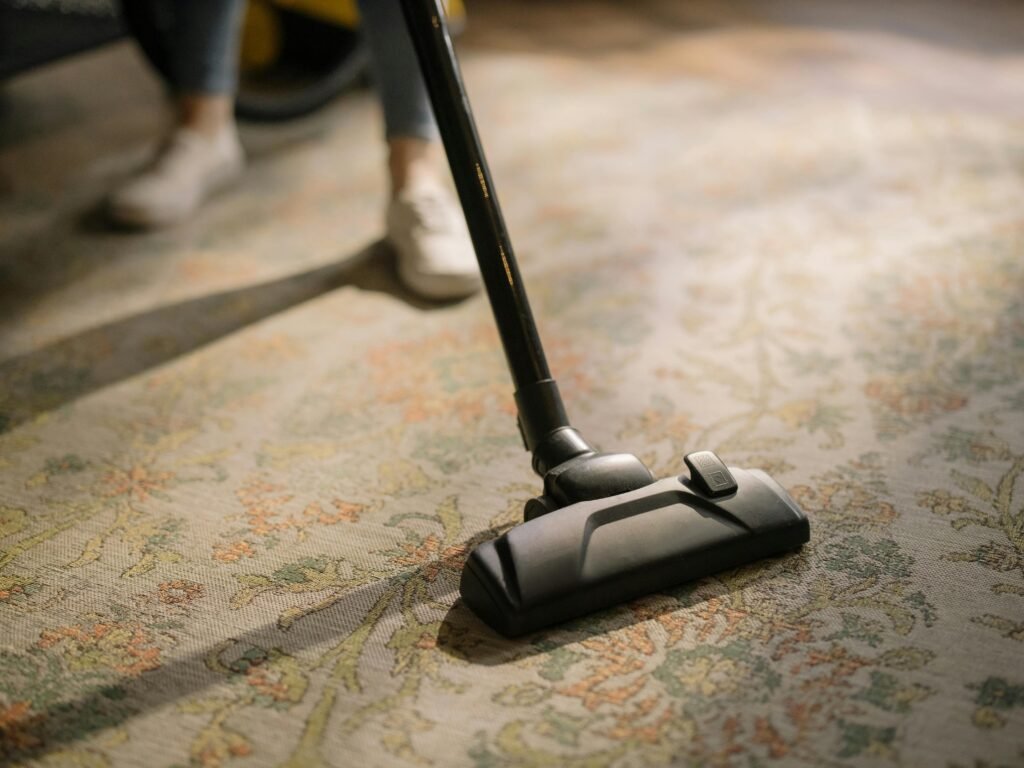 Cleaning staff clean the floor carpet with vacuum cleaner