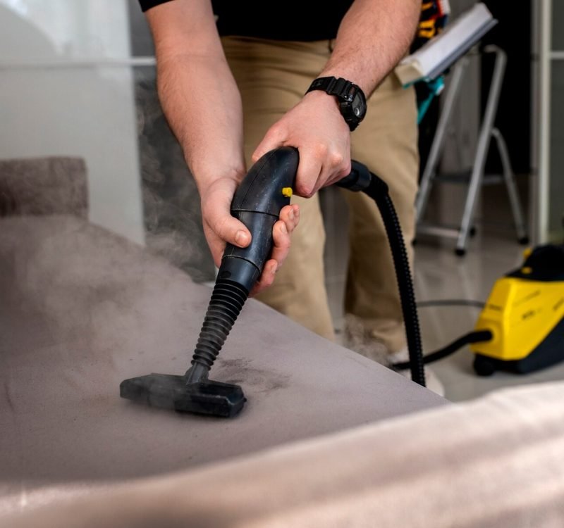 man-doing-professional-home-cleaning-service_23-2150359024 Man vacuuming a couch
